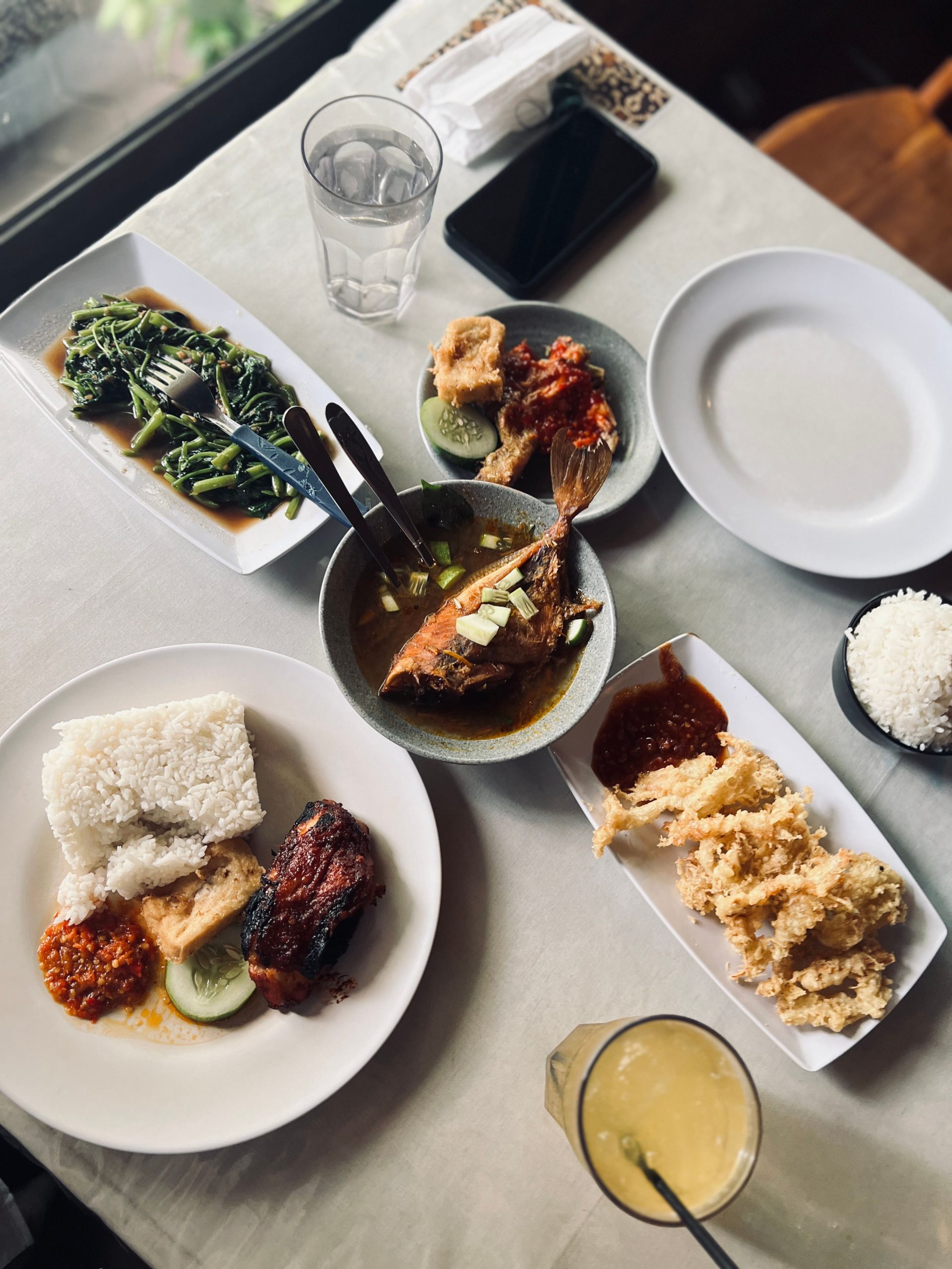 An overhead view of several Indonesian dishes plated together