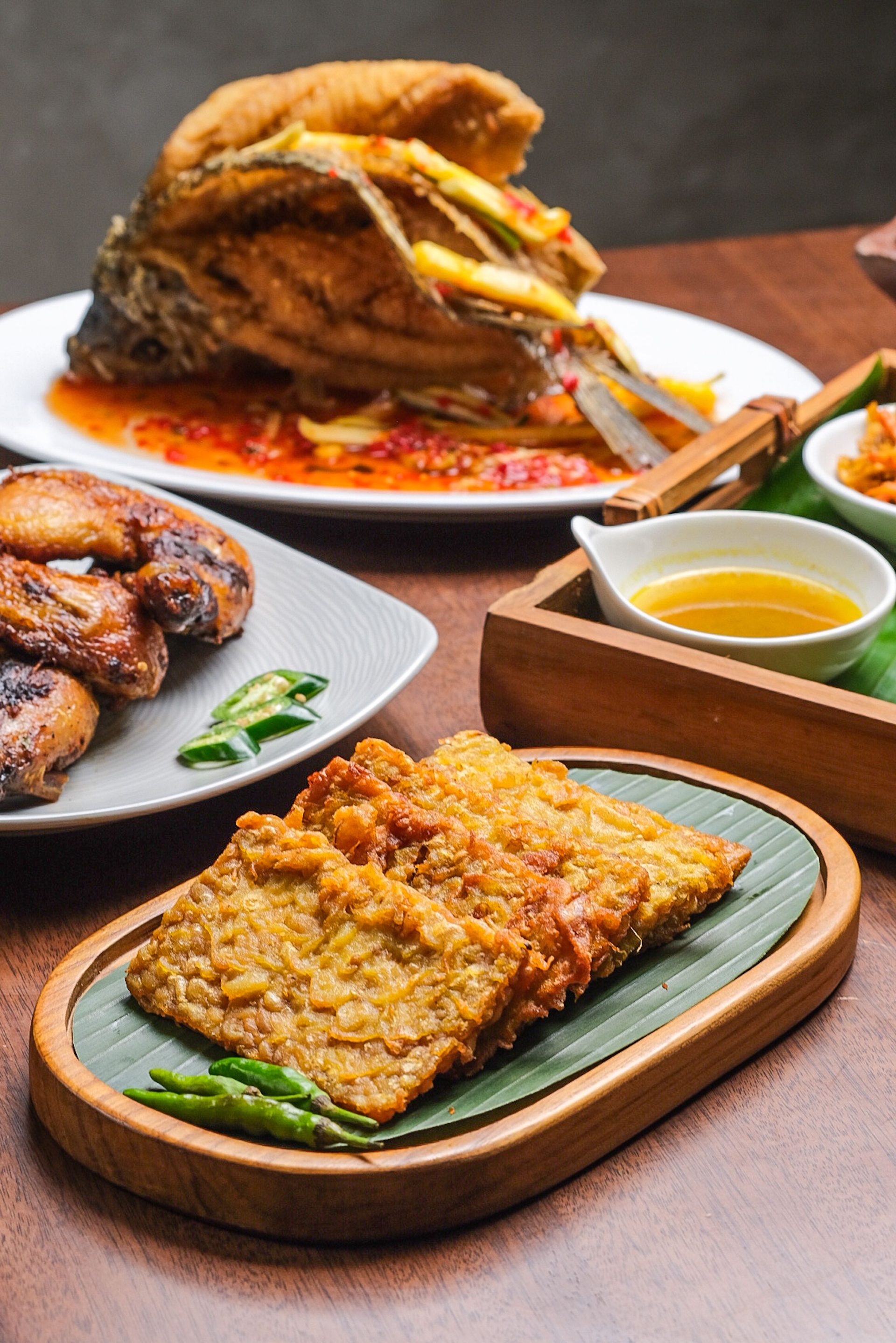 Plates of fried dishes served with rice and sauce