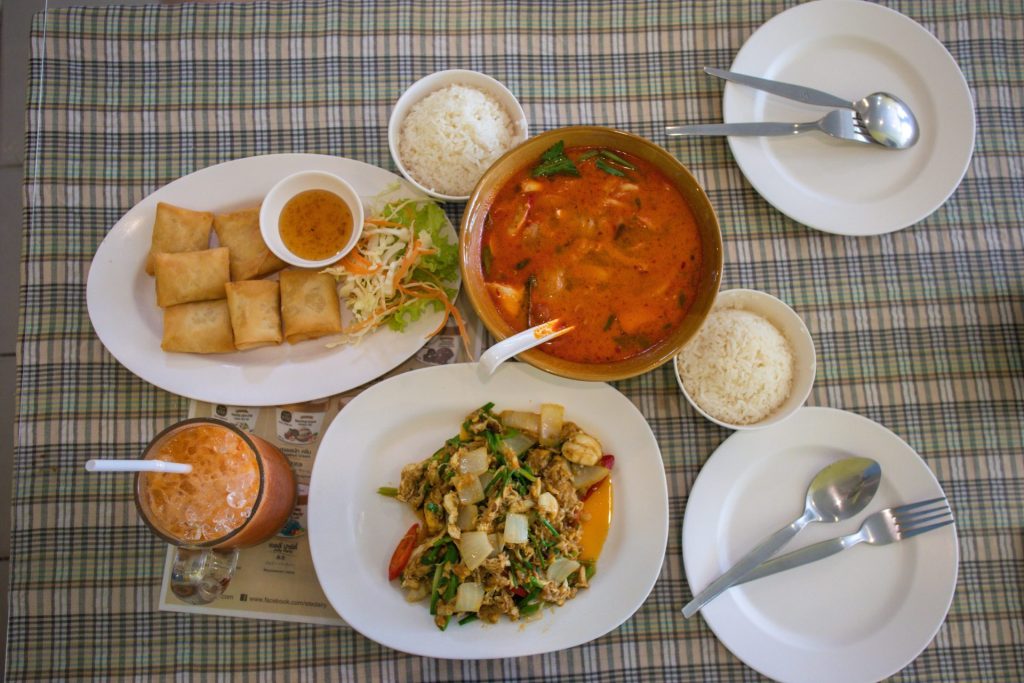 Bangkok street food vendors cooking fresh Thai dishes at a busy market