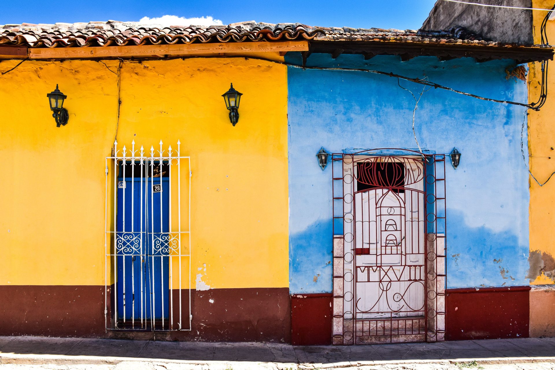 A row of brightly painted colonial houses on a Havana street