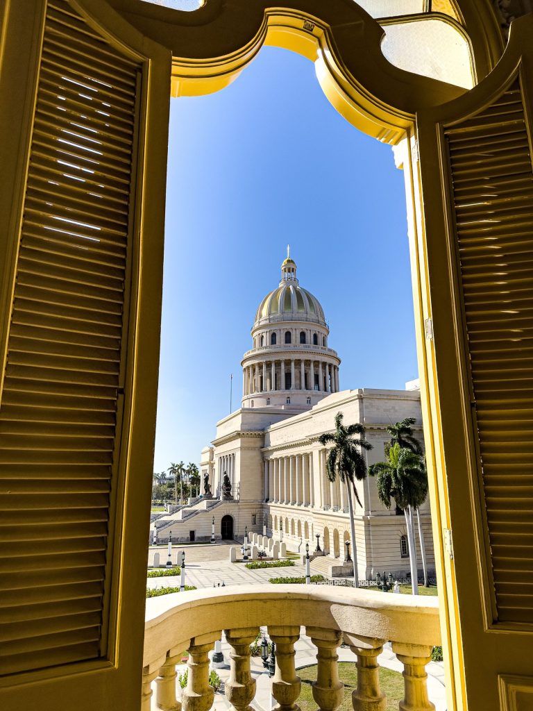 View of the Capitolio dome framed by a golden window, seen from above