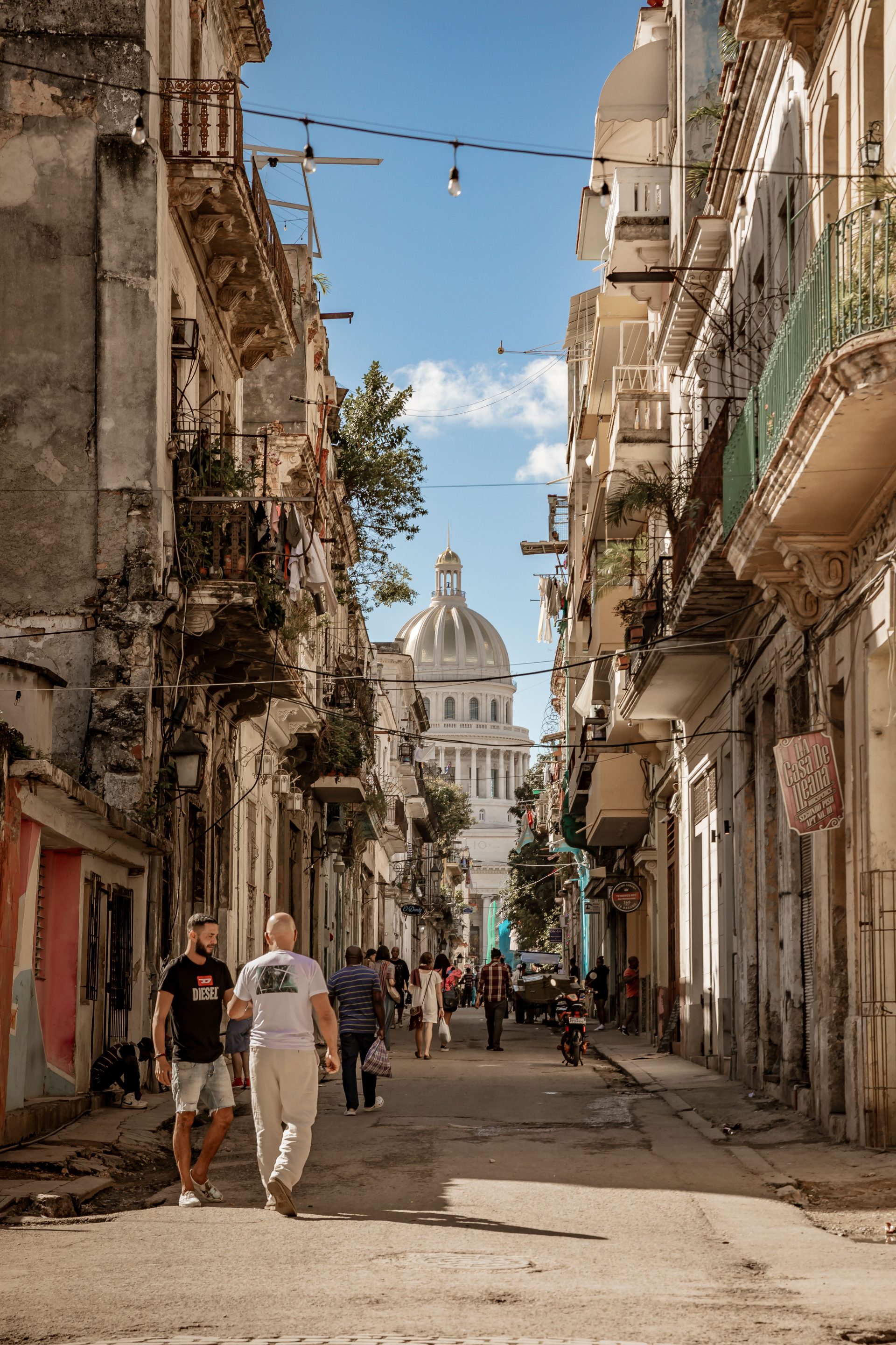 A street-level view of Havana with the Capitolio in the distance