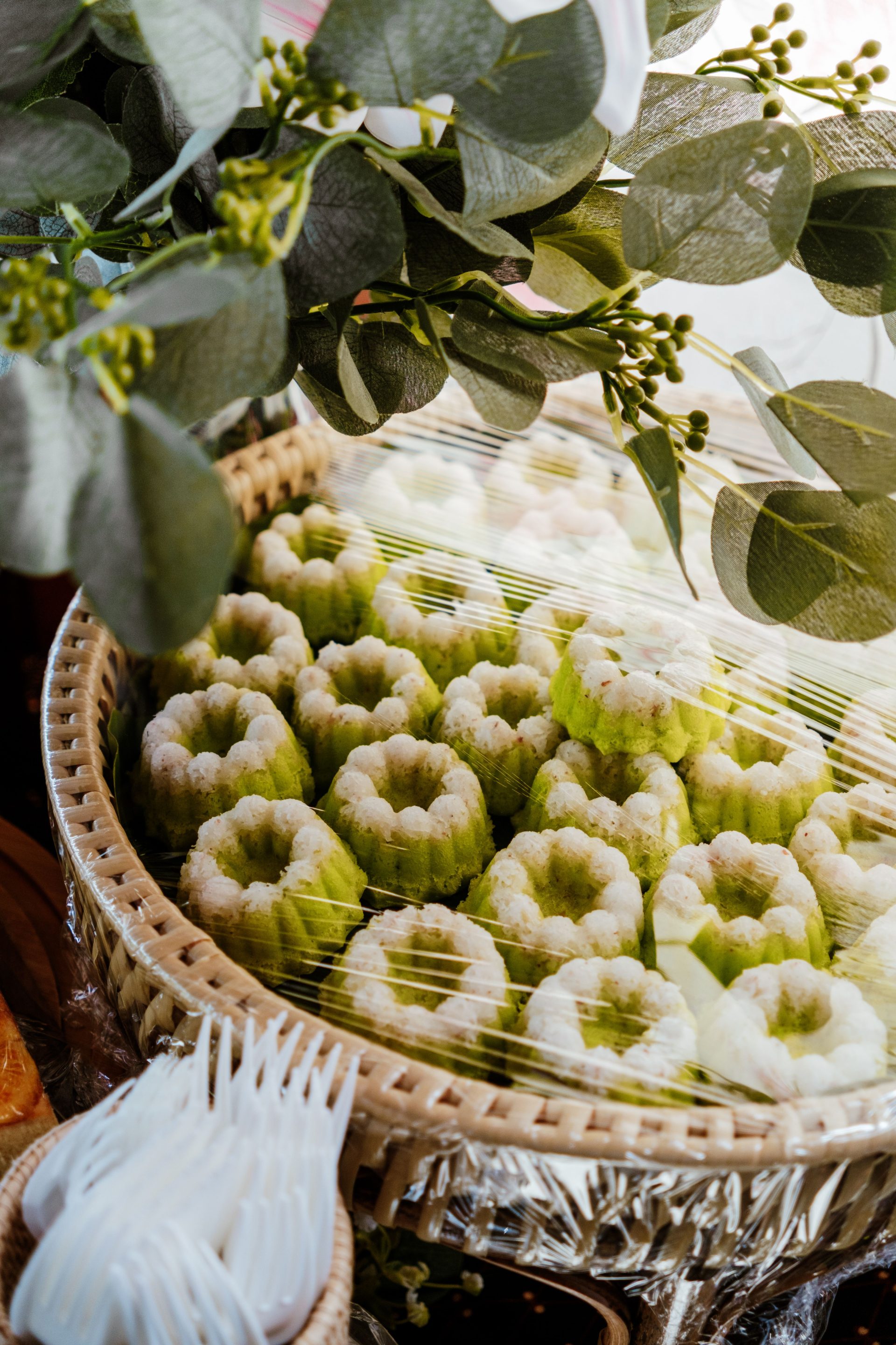 Pandan kuih cakes cooling in flower-shaped molds