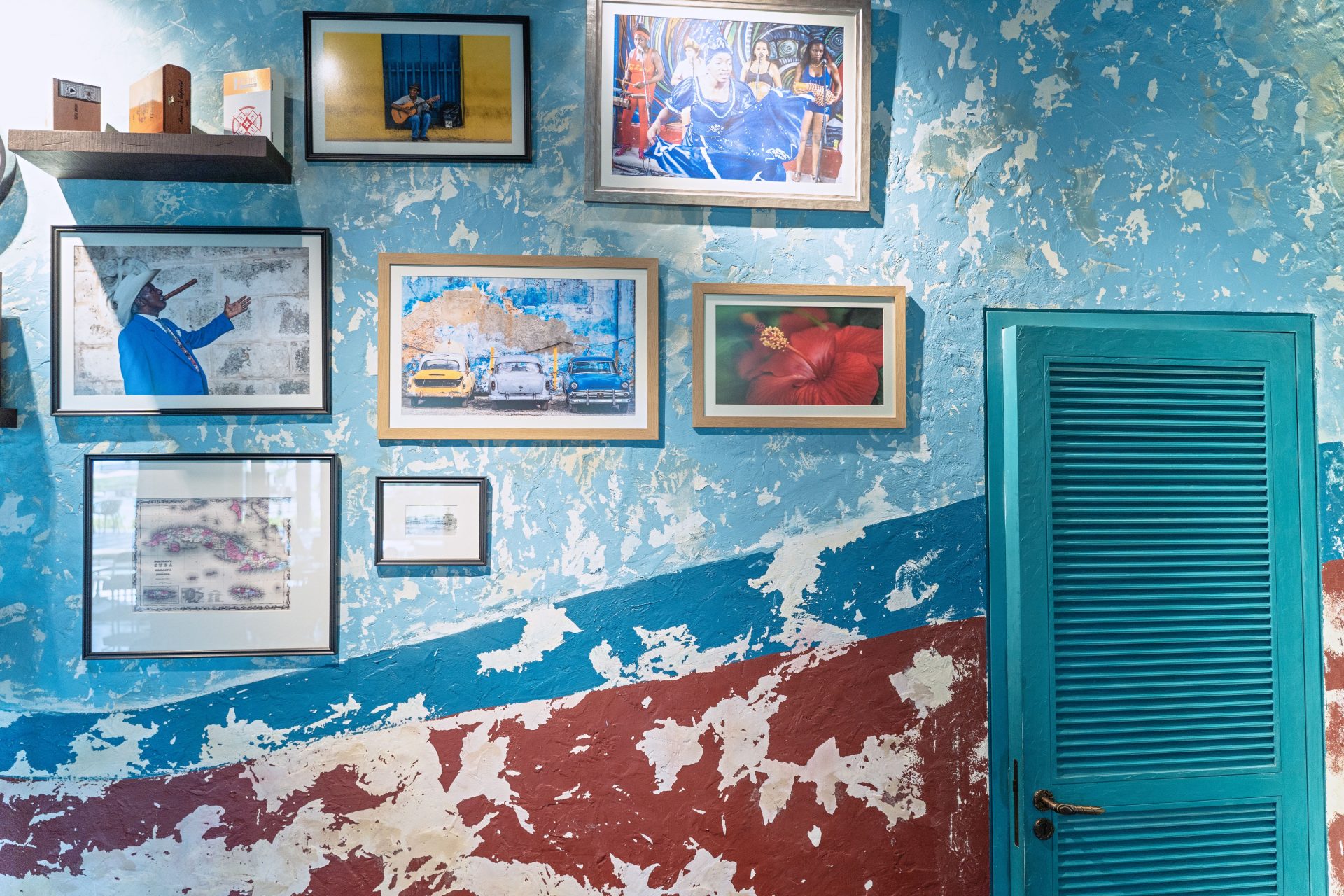 A gallery wall of framed artworks in a Havana interior