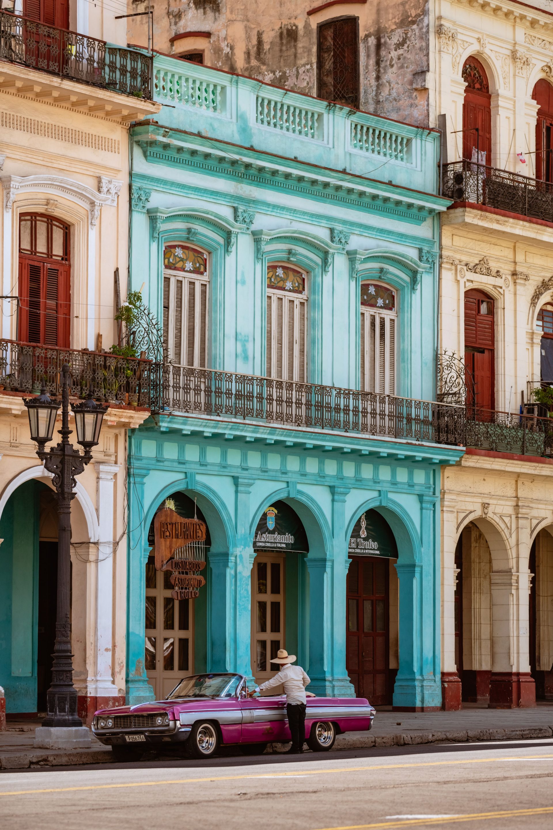 A pastel colonial facade with tall windows