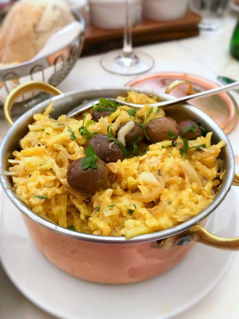 Bacalhau a Bras with potatoes eggs and olives in Lisbon