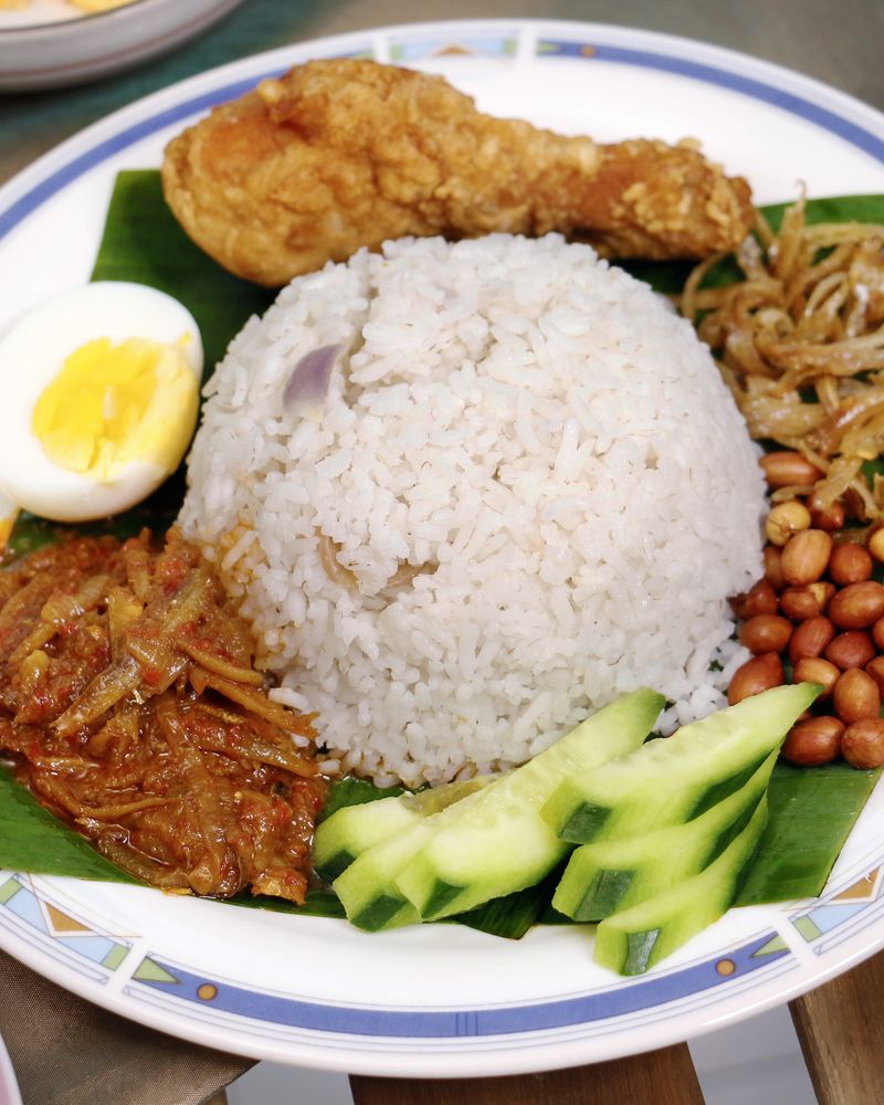Nasi lemak plate with coconut rice, sambal, egg, and peanuts
