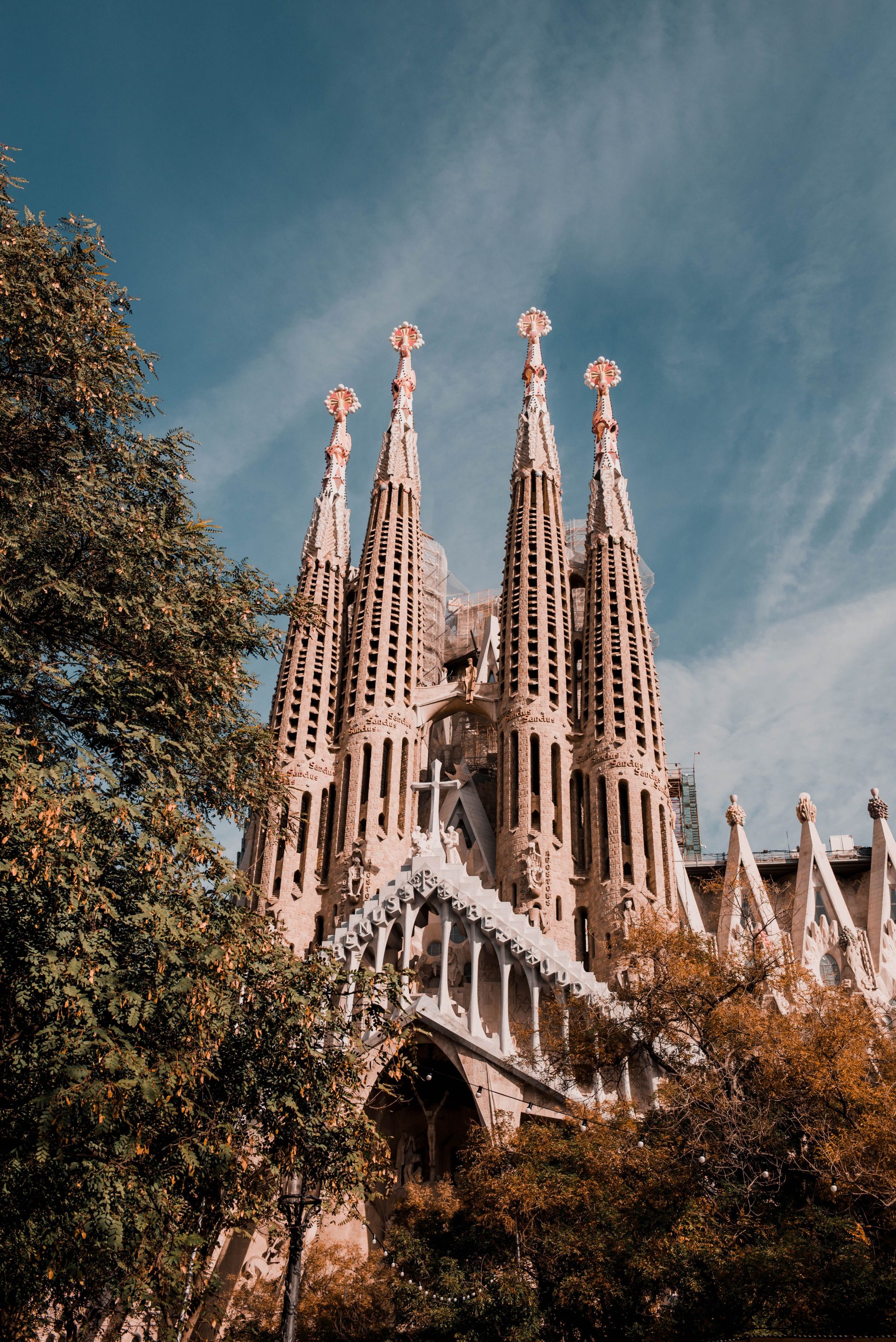 The Sagrada Familia towers seen from below against a bright sky