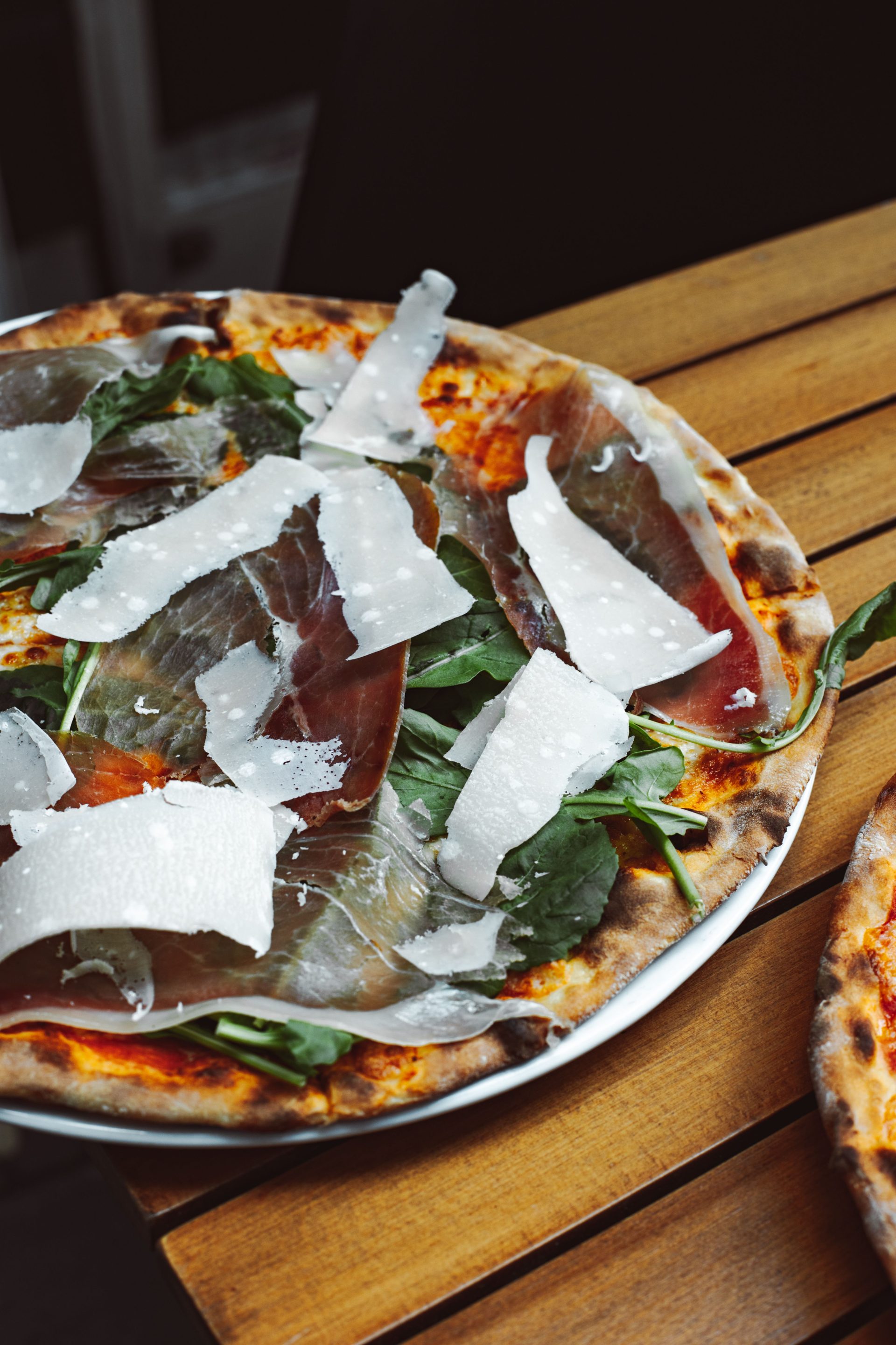 Rectangular pizza al taglio being cut and sold by weight