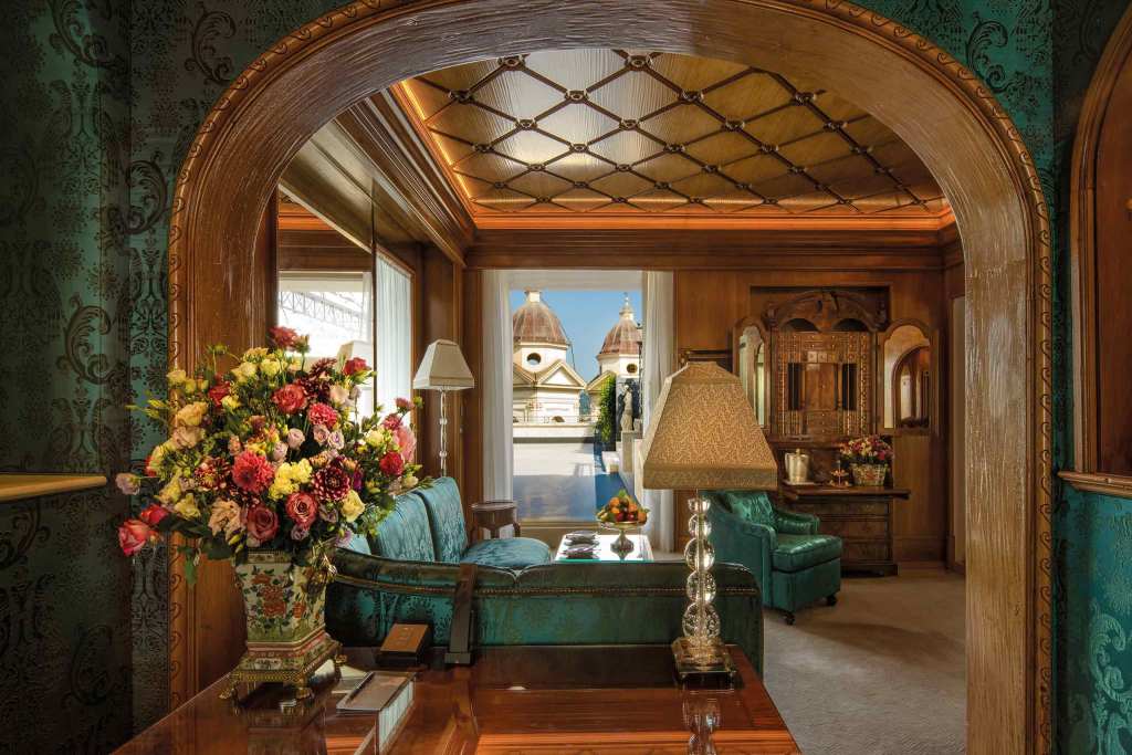 A wood-panelled suite salon at Hotel Hassler looking out to the bell towers of Trinita dei Monti