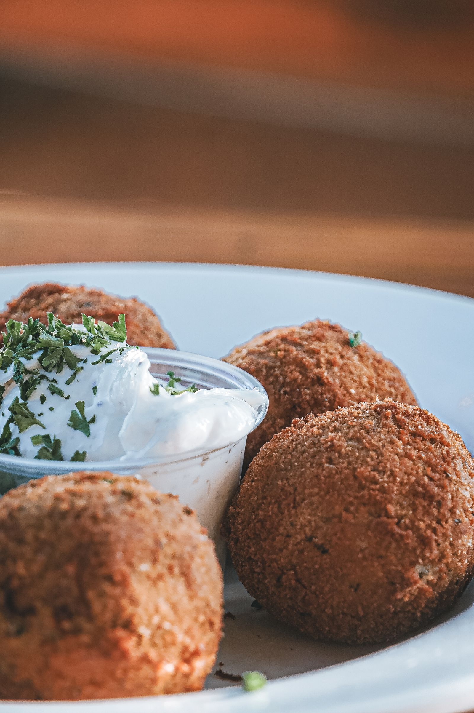 Golden bechamel croquetas beside a bowl of alioli at a Barcelona tapas bar