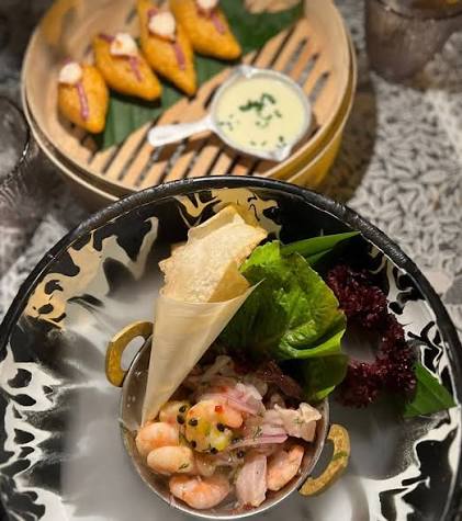 A platter of small Cartagena dishes with avocado, beans and corn cakes
