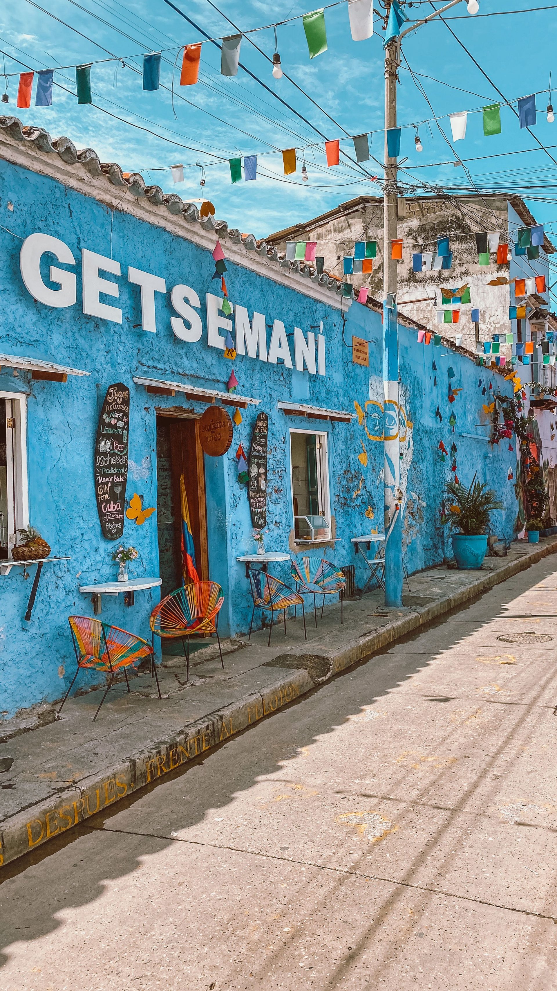 A street in Getsemani, Cartagena hung with flags above painted houses