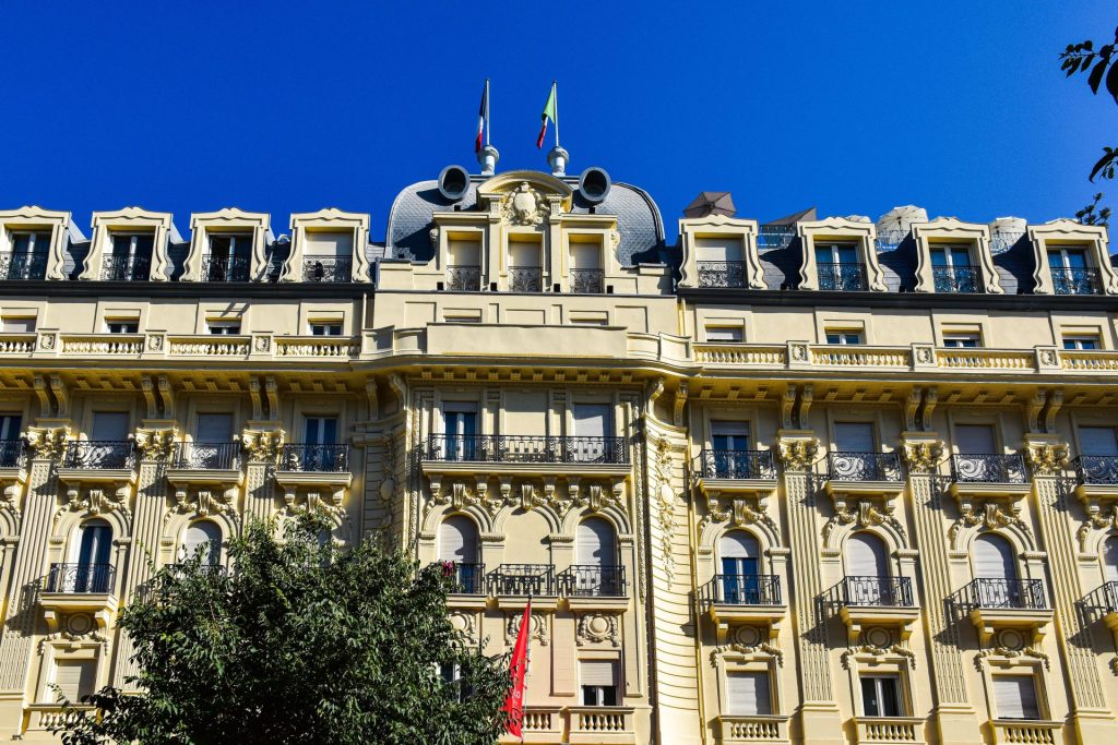 The belle-epoque facade of a grand hotel in central Rome, flags above the entrance