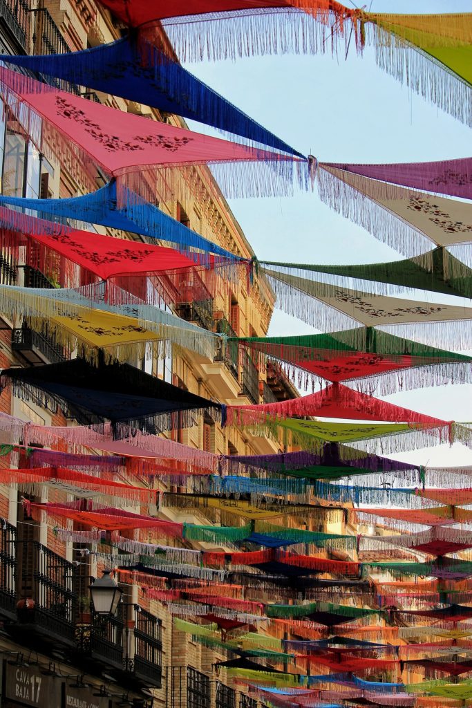 Coloured paper bunting strung across a street for a neighbourhood fiesta