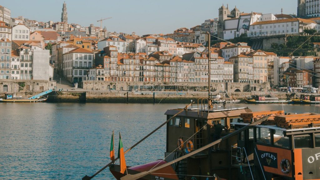 Things to do in Porto: the Ribeira waterfront stacked above the Douro, with a rabelo boat moored