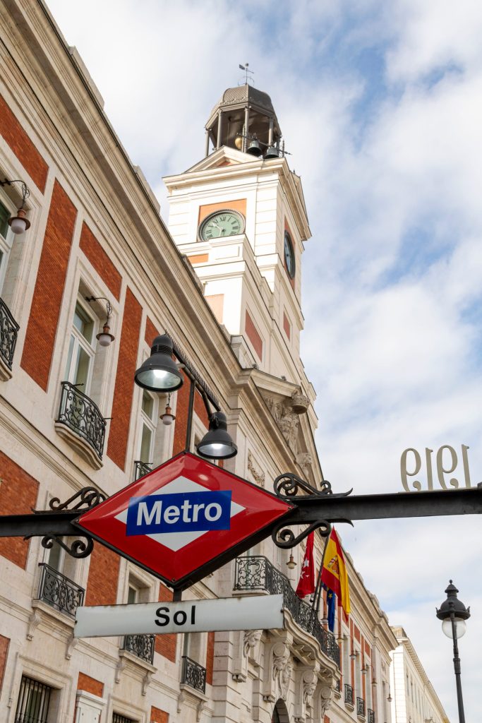 A Metro sign at Sol station beneath the clock tower