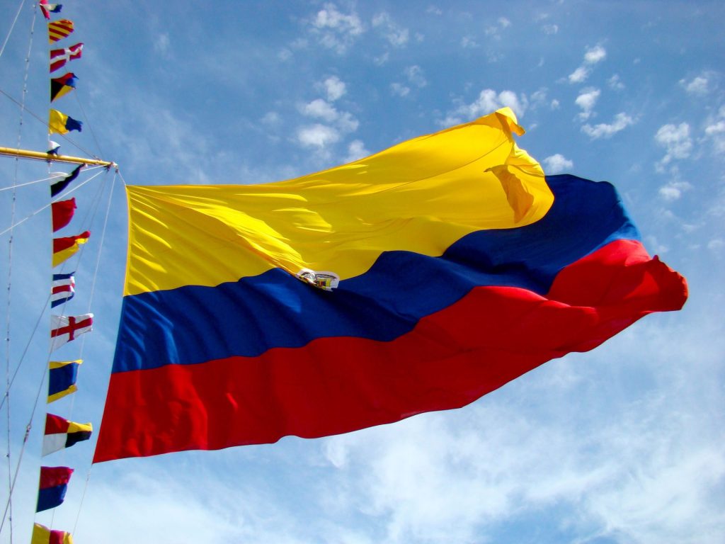 Colombian flag against blue sky illustrating the is Colombia safe travel guide