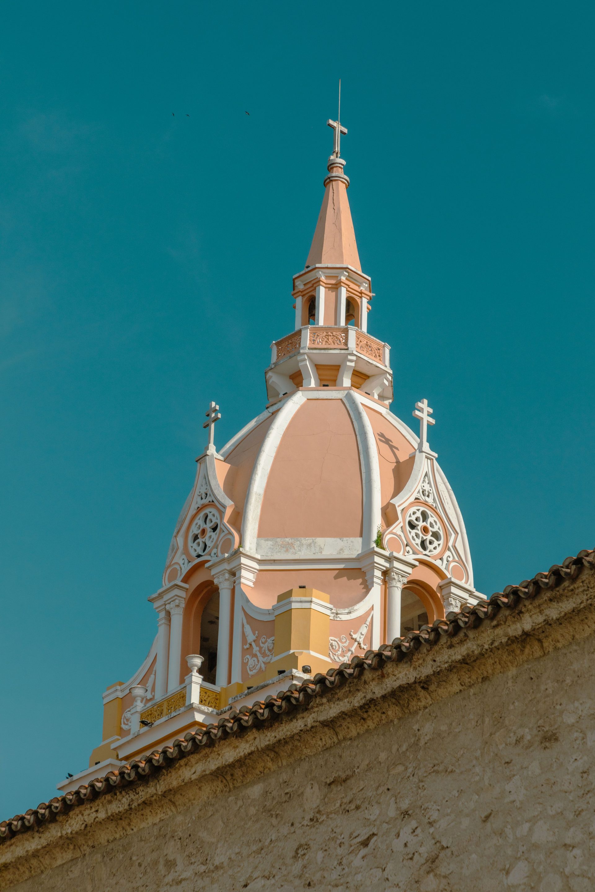The domed clock tower of Cartagena cathedral rising above a pale wall
