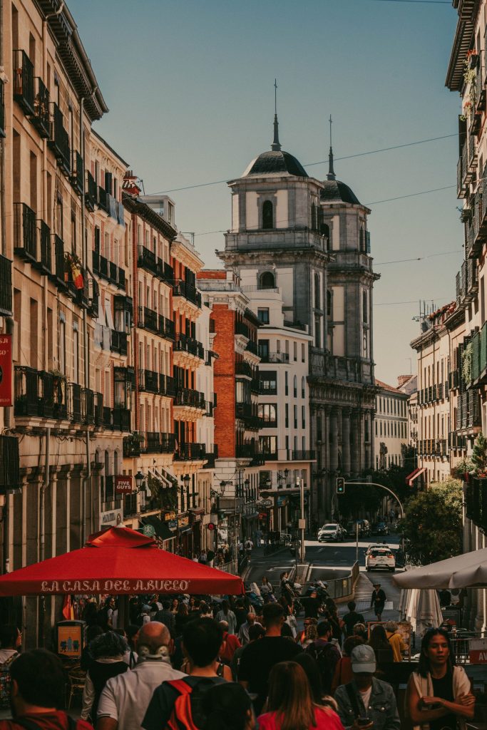 A busy street of tapas bars with terrace awnings