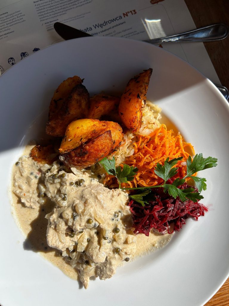 A plate of roasted potatoes, grated salads and a creamy dish