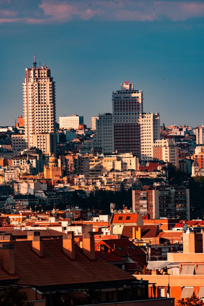 The Madrid skyline at sunset above terracotta rooftops