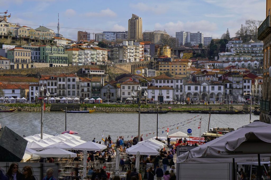 Best restaurants in Porto: market stalls along the Douro with the Ribeira houses rising behind