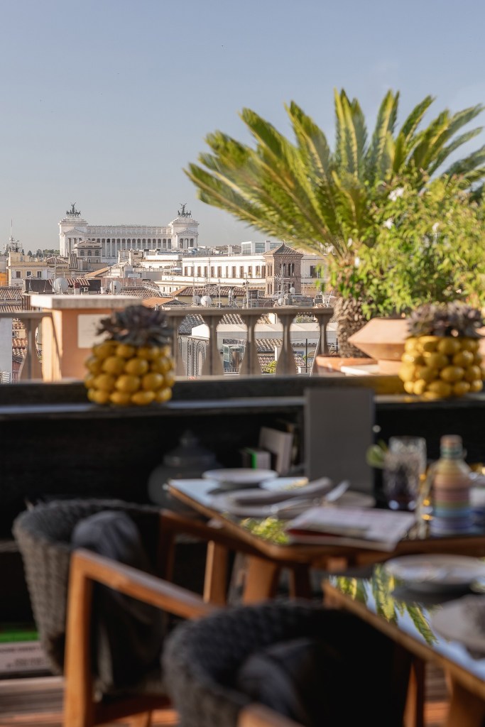 Breakfast laid out on the terrace at Portrait Roma with a view over the rooftops