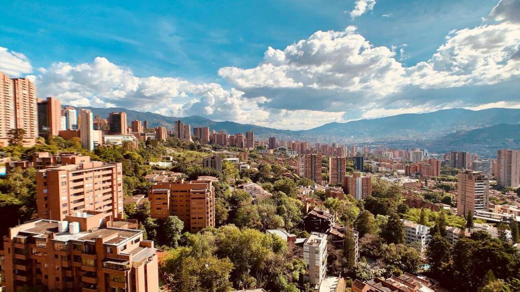 Apartment towers in El Poblado, Medellín, against the green hills of the valley