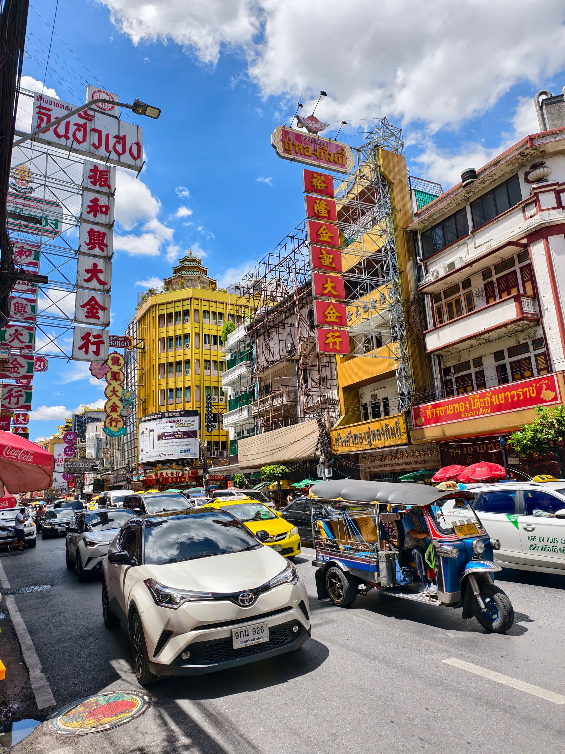A busy street lined with Chinese shophouse signage in Bangkok