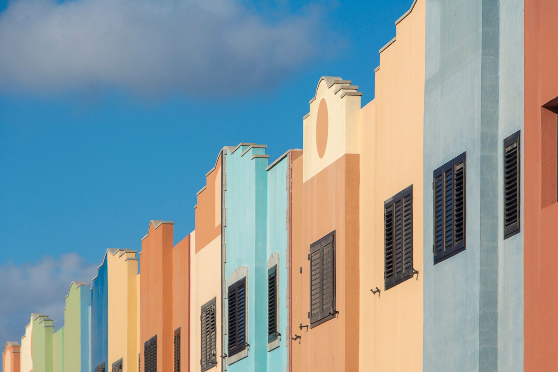 Multicoloured Caribbean building facades under a clear blue sky