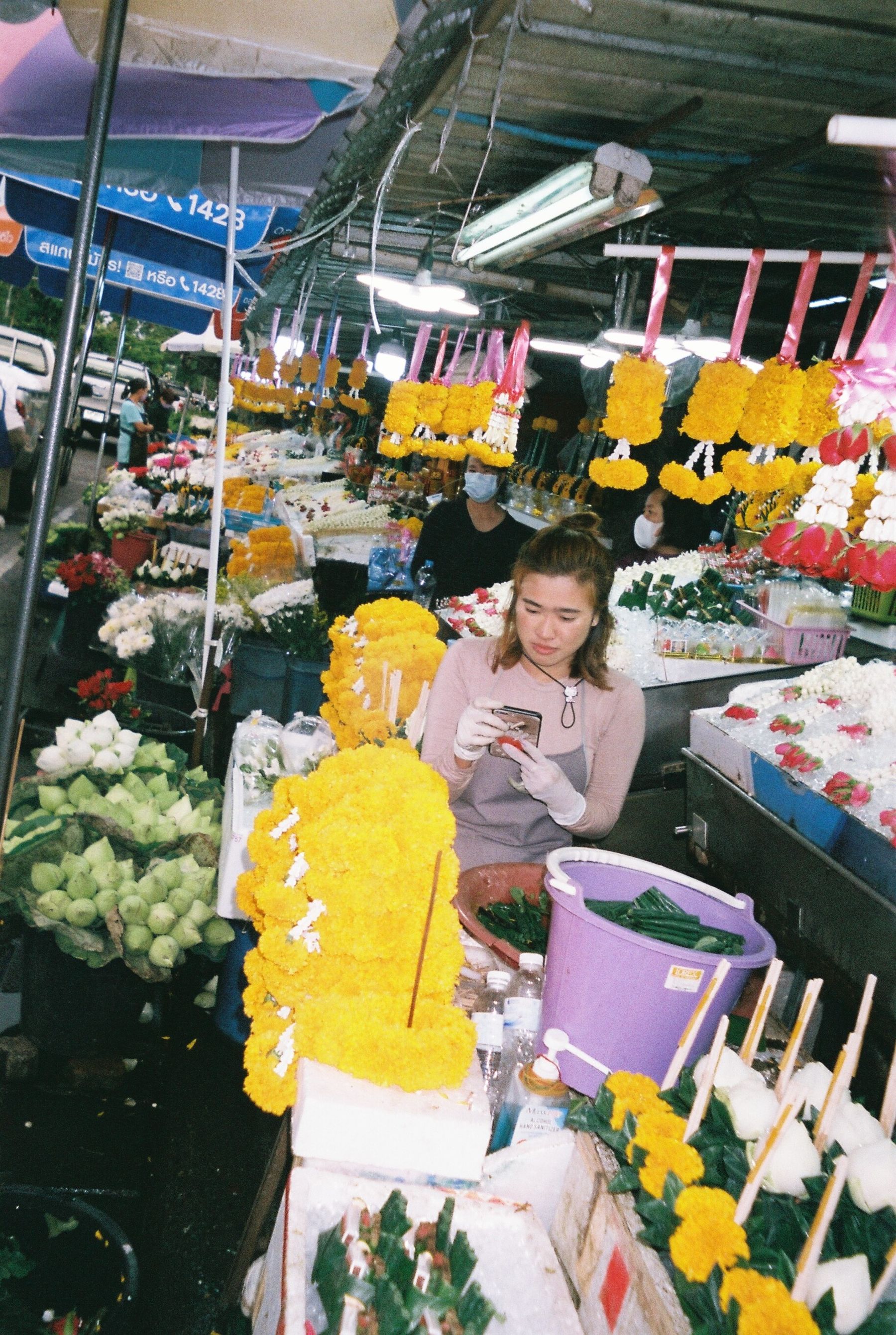 A stall holder arranging her display at a Chiang Mai market