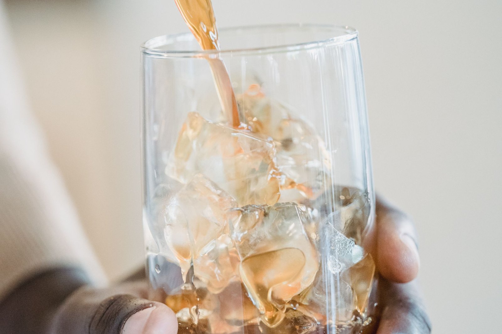 A tall iced drink in a glass on a table
