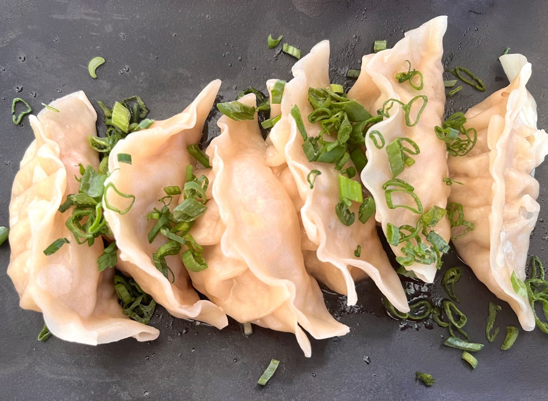 A plate of dumplings at a street-level shop
