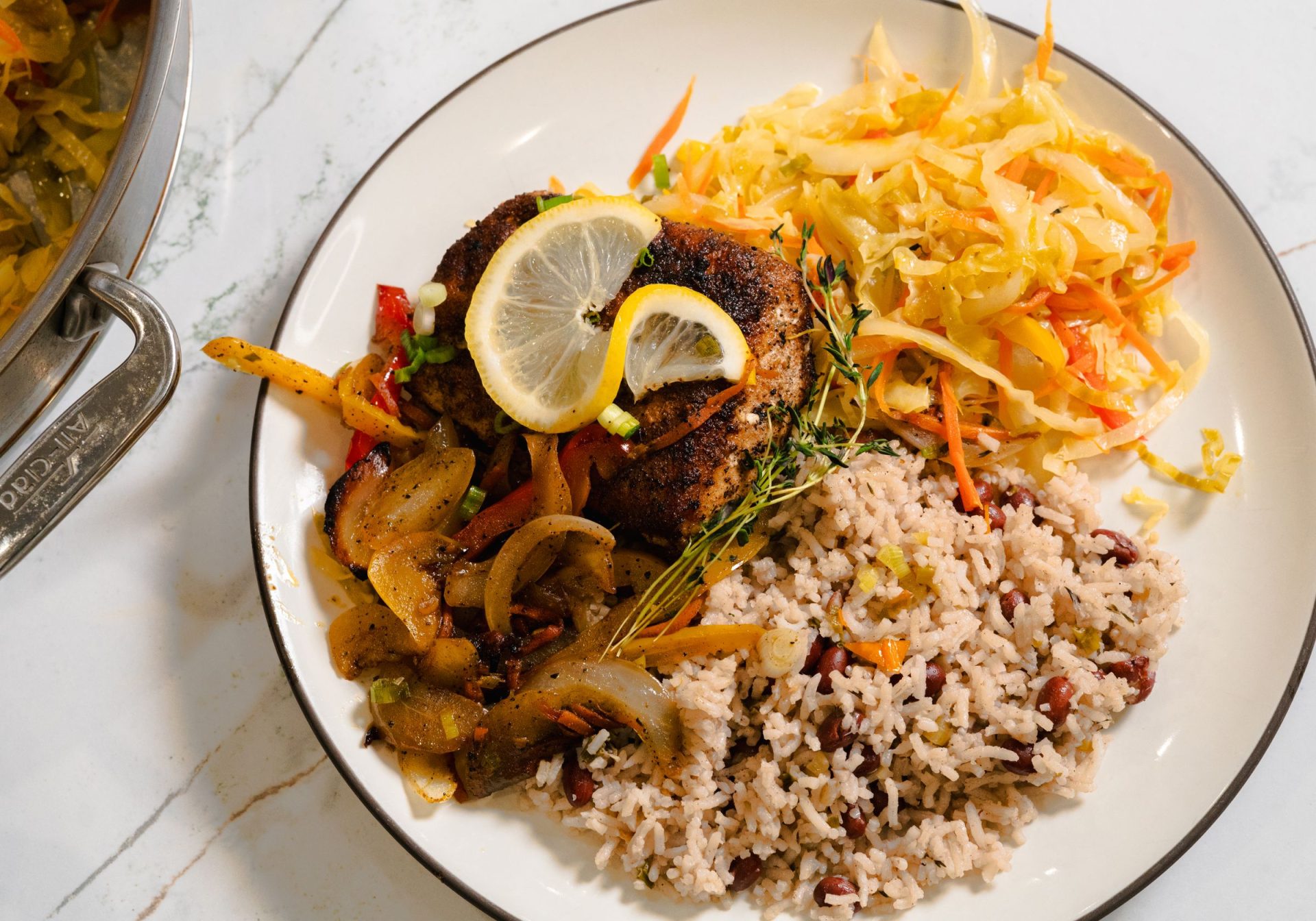 Jamaican escovitch fish with rice and peas and cabbage slaw