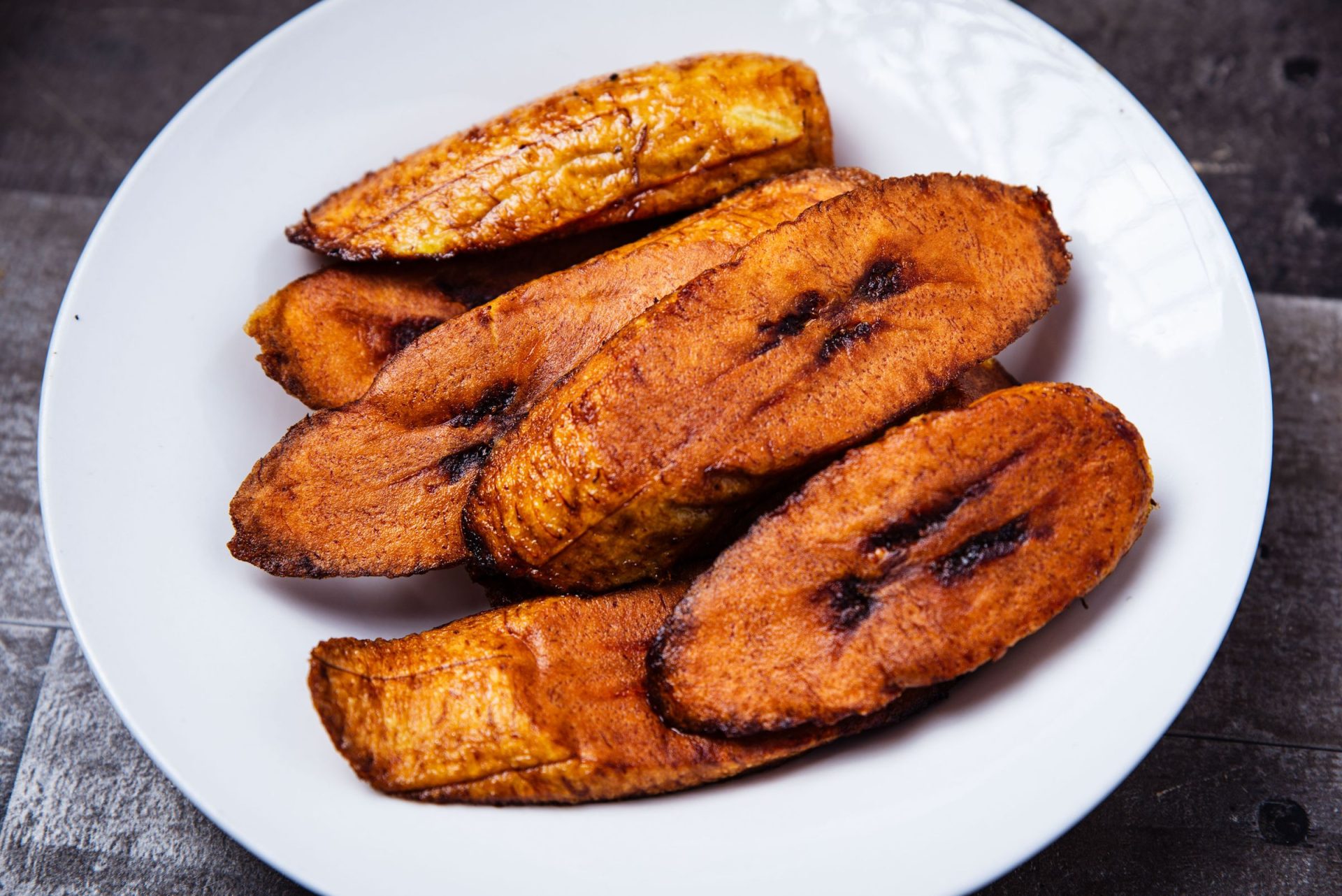 Crispy fried plantains served on a white plate