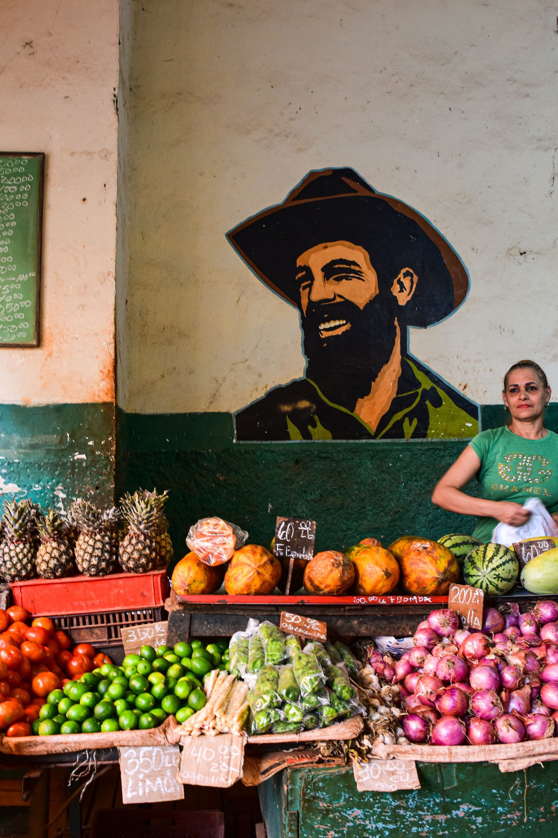 Fruit market in Havana with local produce and a painted mural