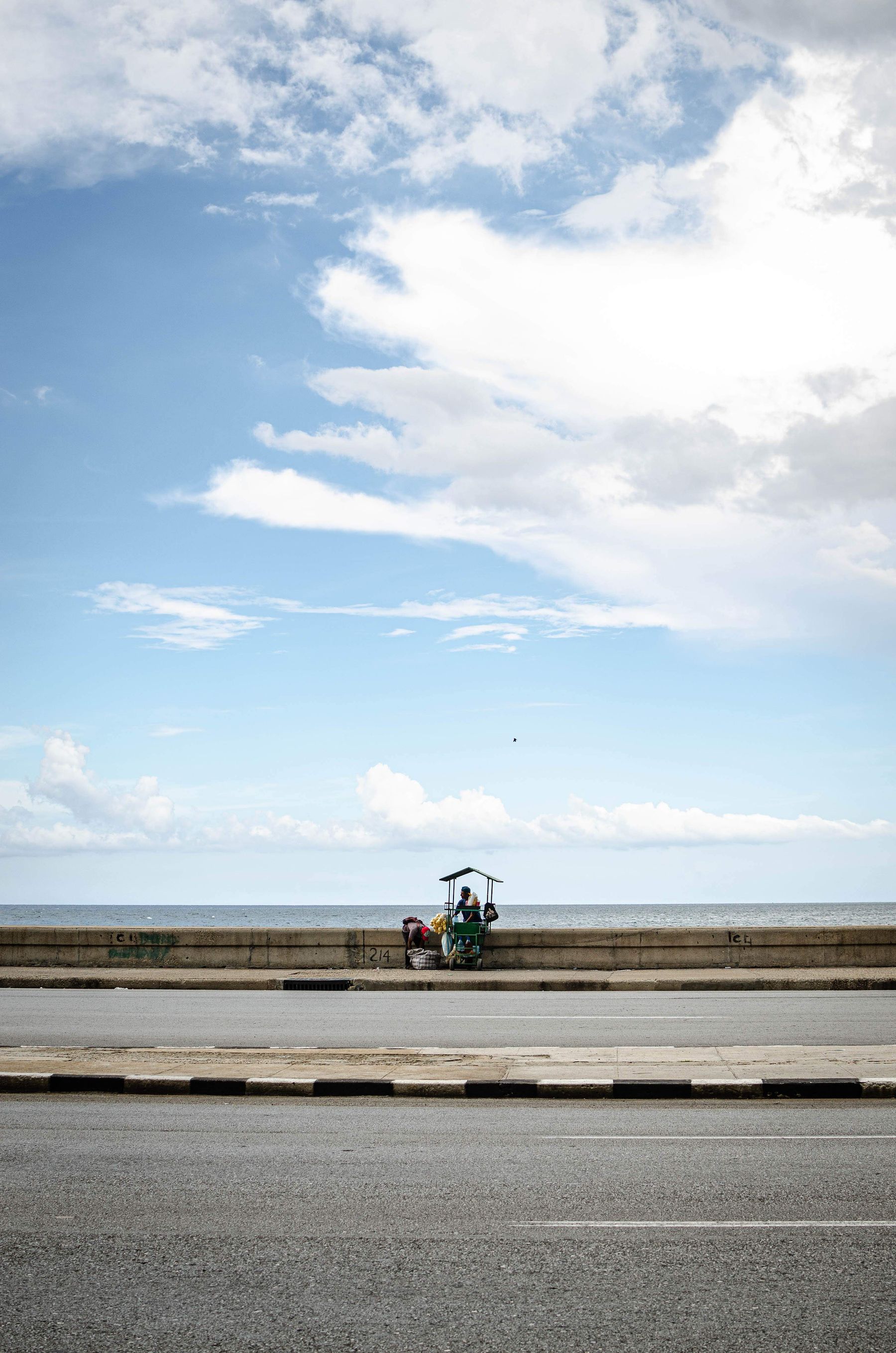 A street vendor with a cart along the Malecon in Havana