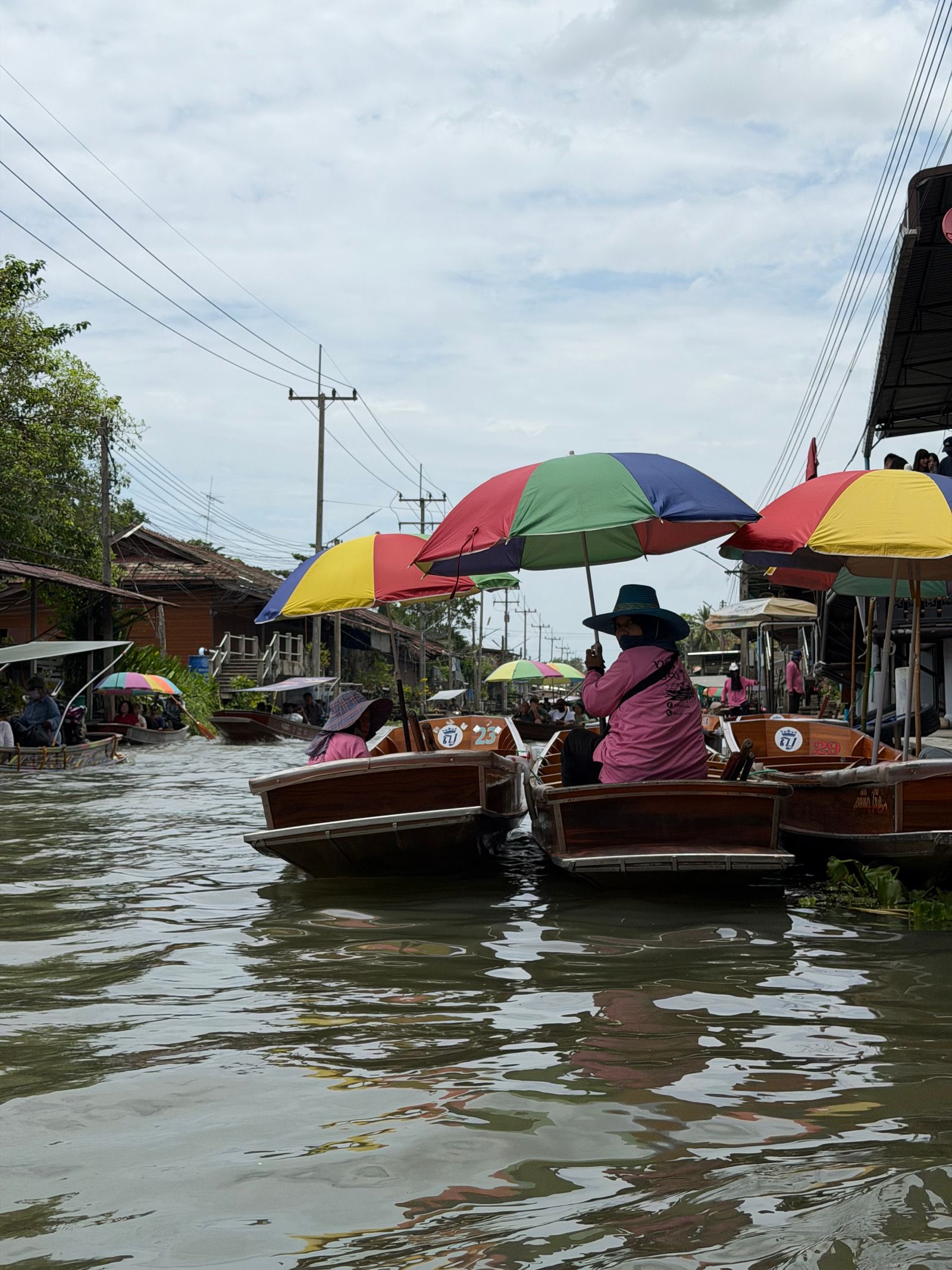 Boats with umbrellas at a floating market near Bangkok