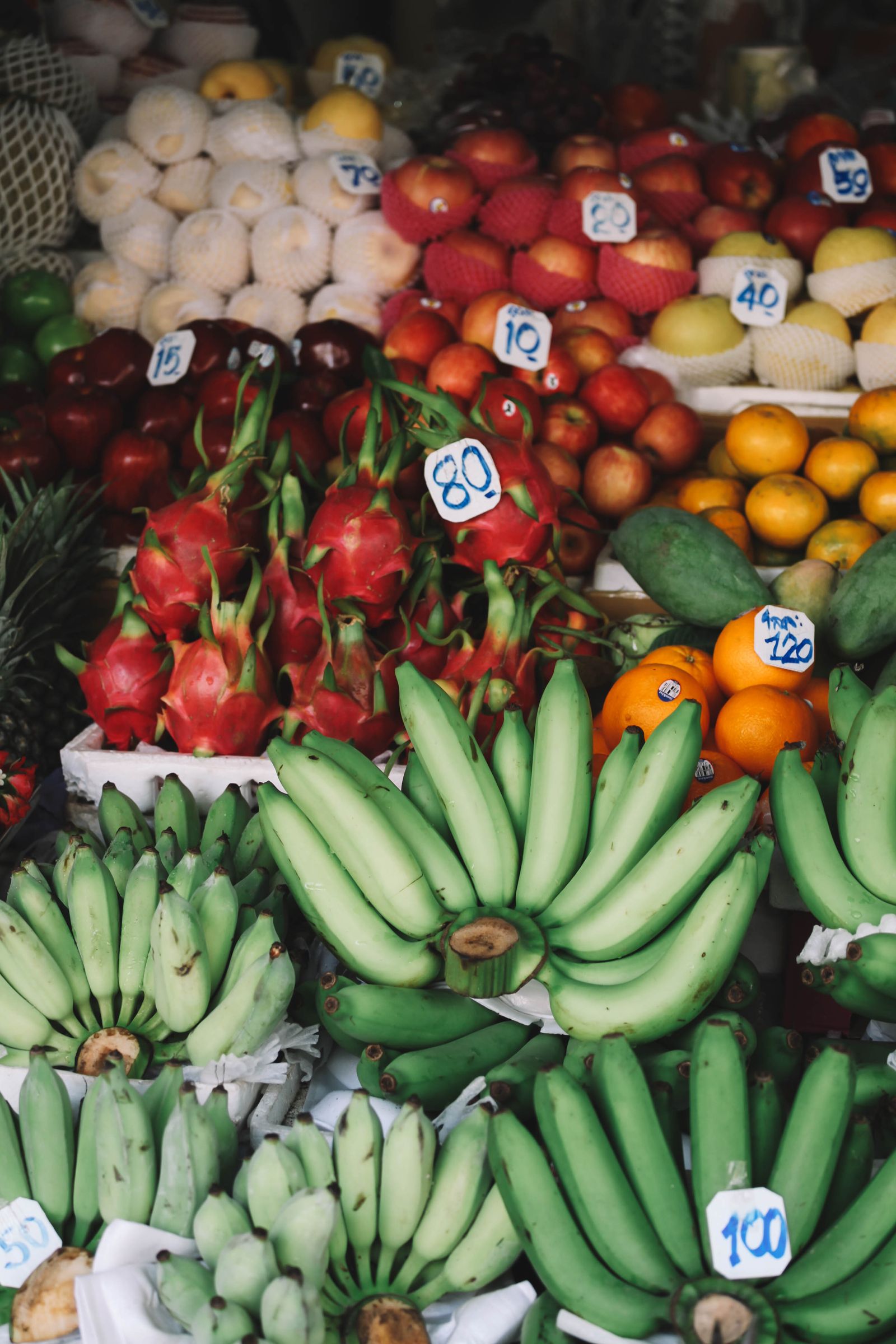Tropical fruit stacked at a Bangkok market stall