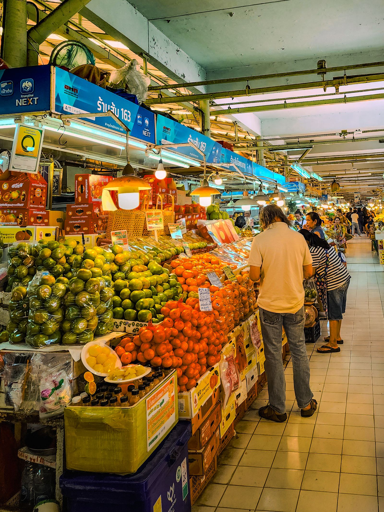 Colourful tropical fruit on display at a bustling Bangkok market