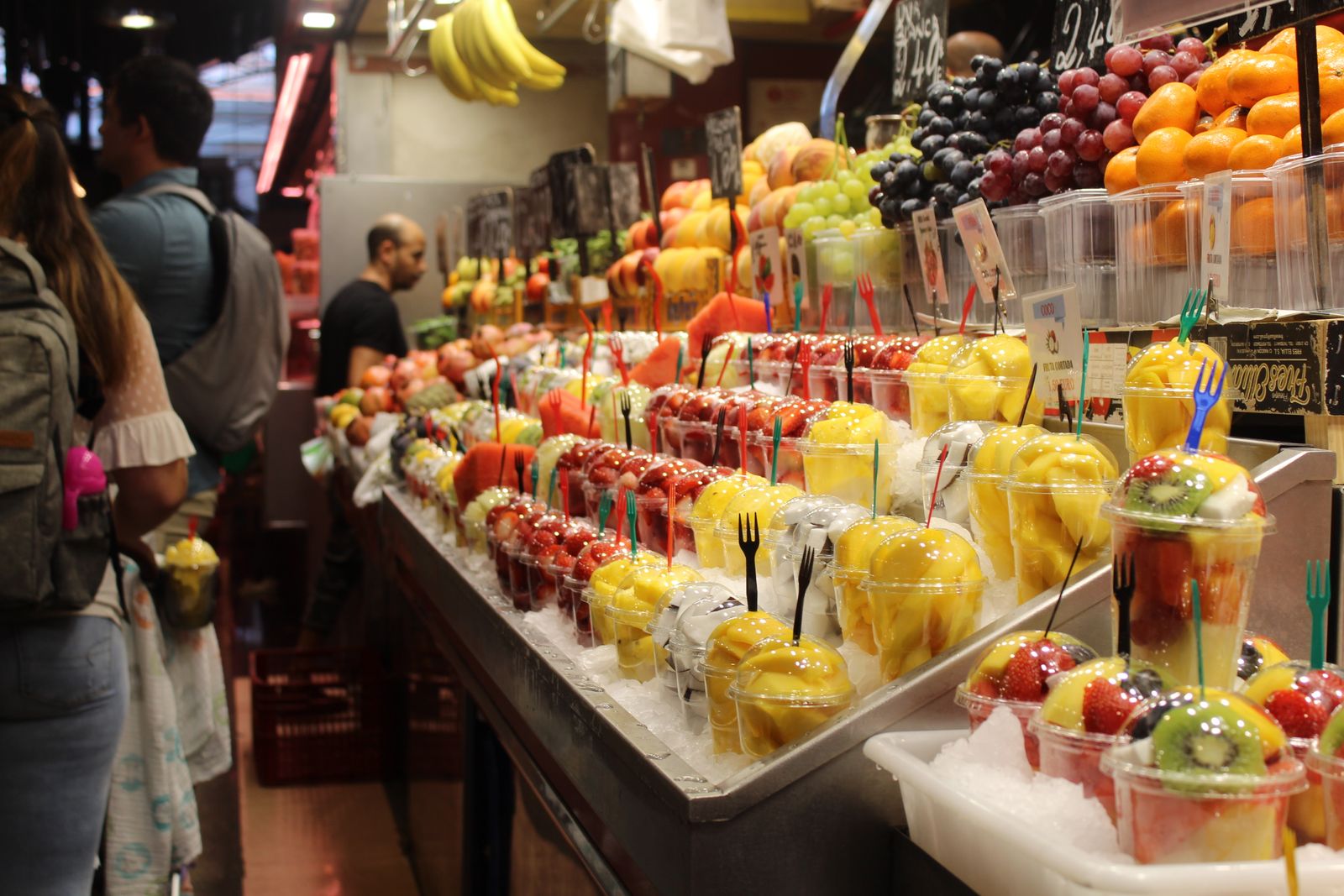 Fresh fruit at a bustling Barcelona market stall