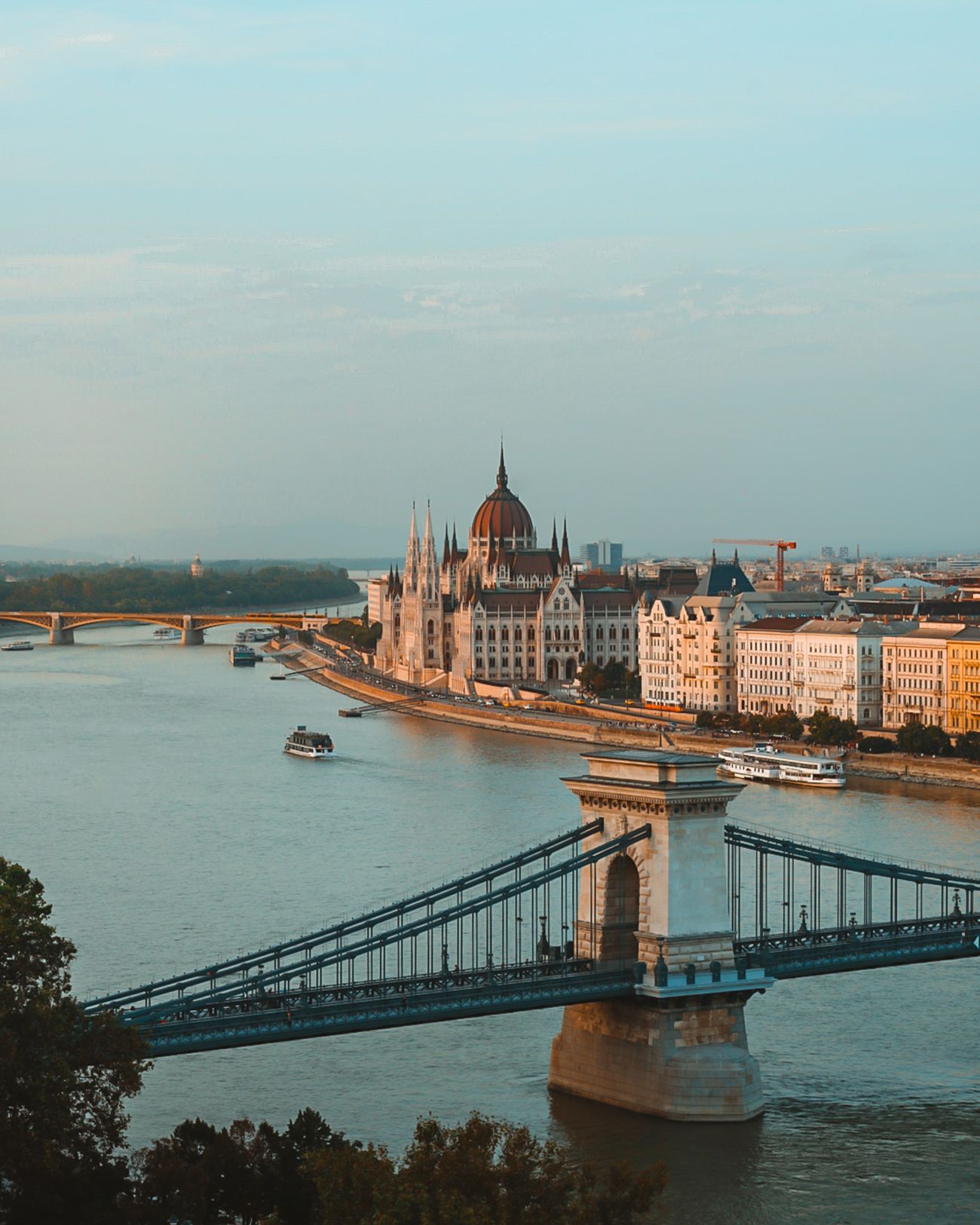 The Danube with the Chain Bridge and the Parliament along the embankment in daylight