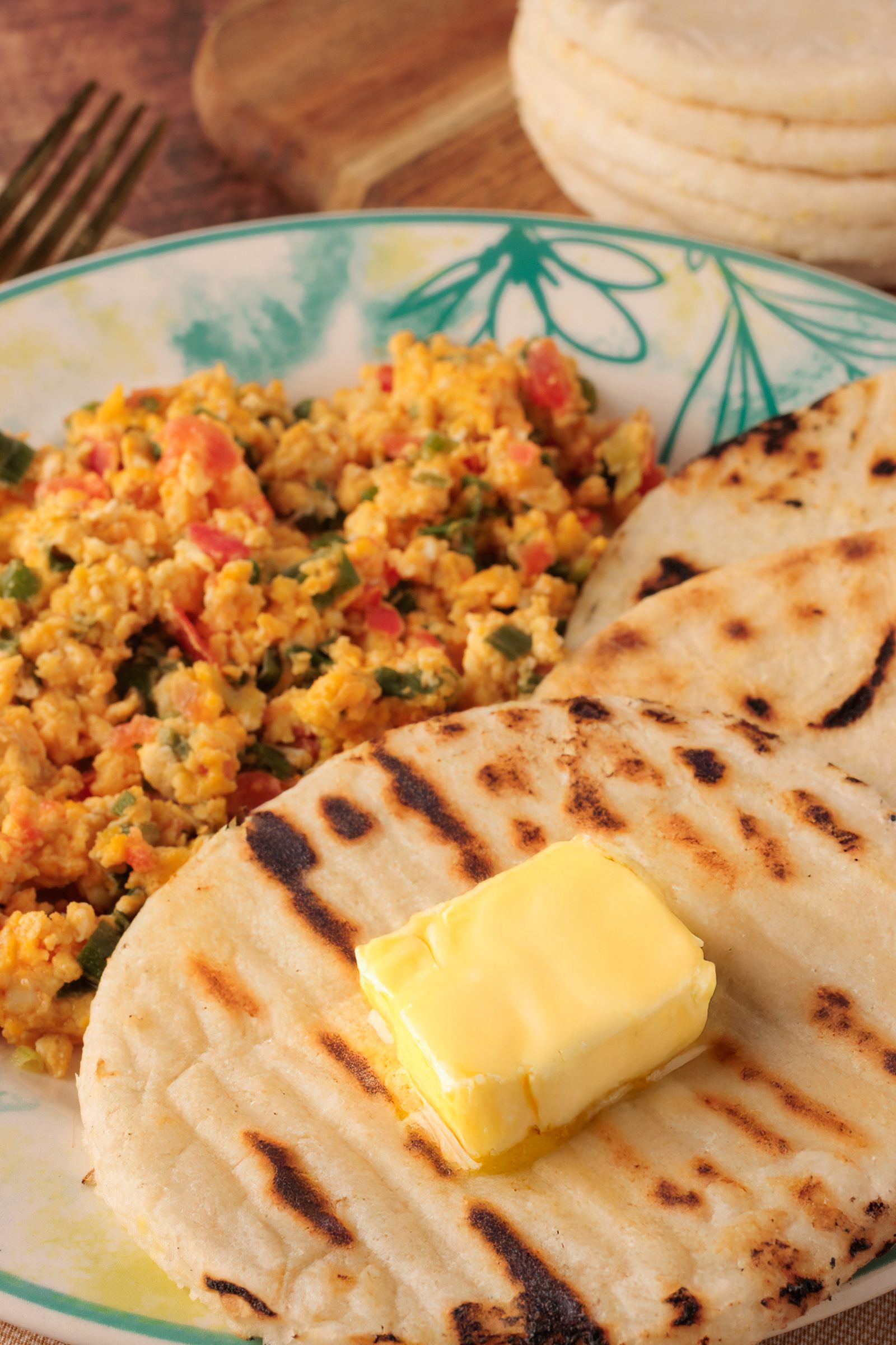 Colombian arepas served with scrambled eggs and butter