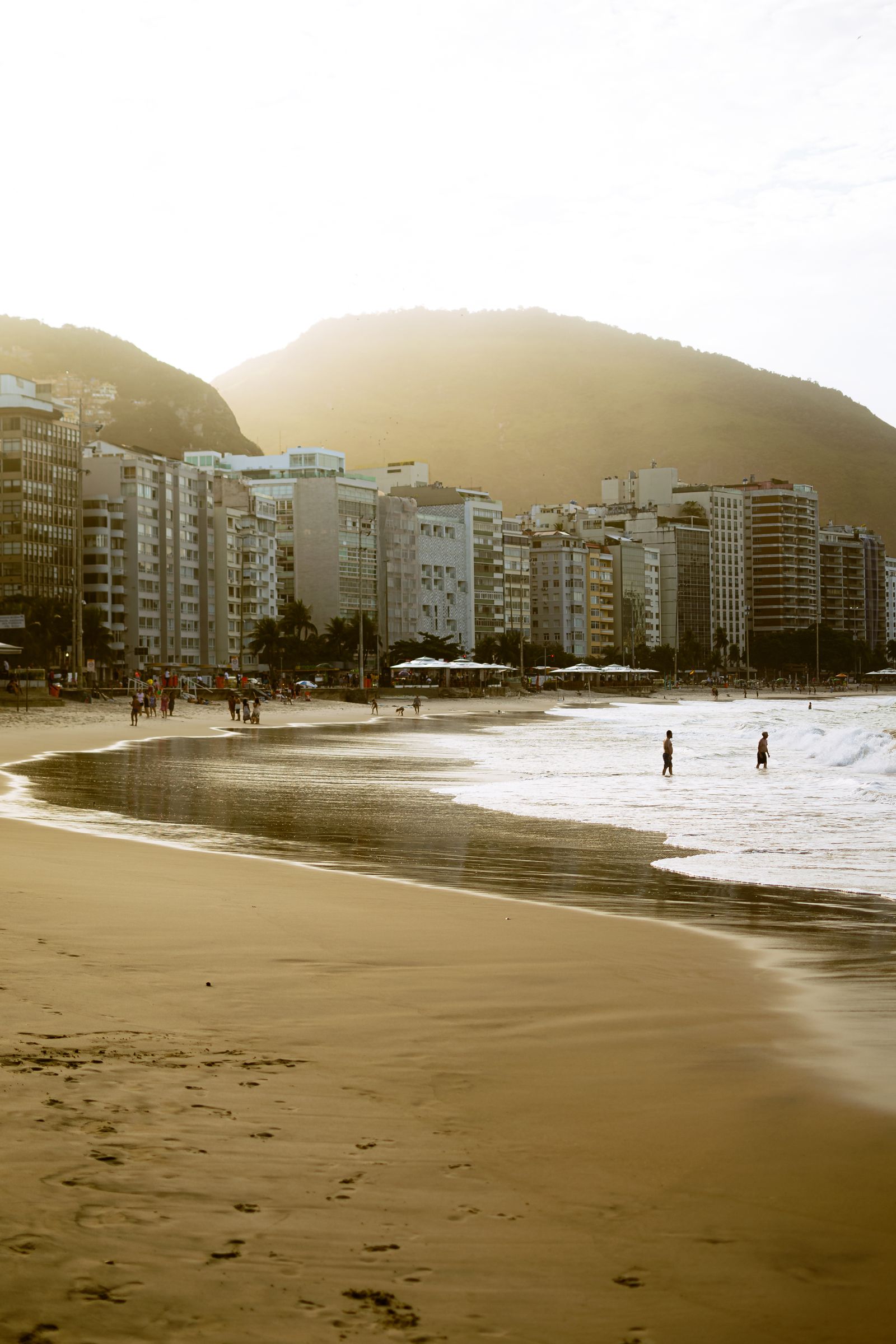 Sunset over Copacabana Beach with the city skyline and distant mountains