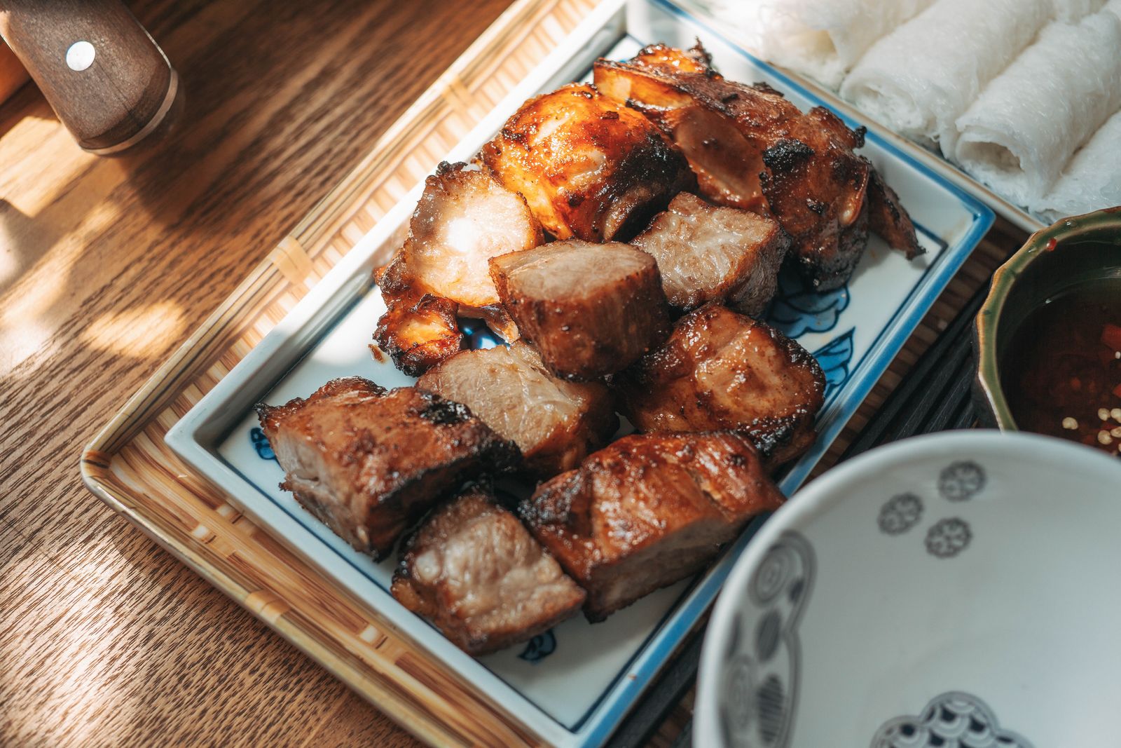 Grilled pork served with rice paper and dipping sauce