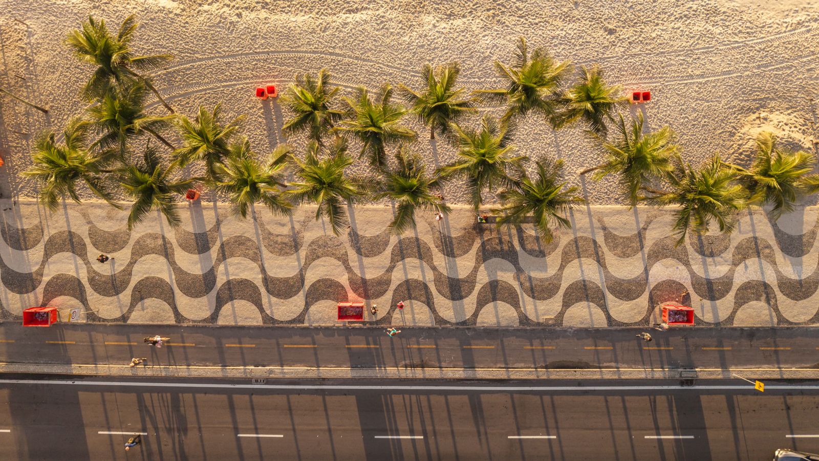 Aerial view of Copacabana Beach in Rio de Janeiro with palm trees and wavy pavement