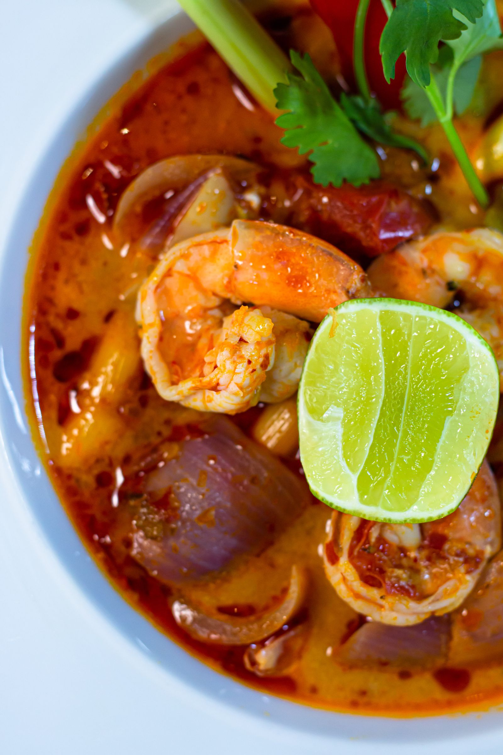 Thai tom yum soup with shrimp, lime and herbs in a rich broth