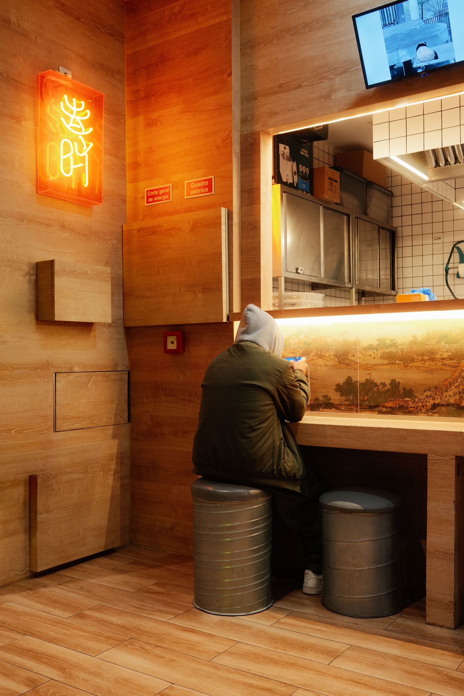 A man standing at a traditional cafe counter in Lisbon