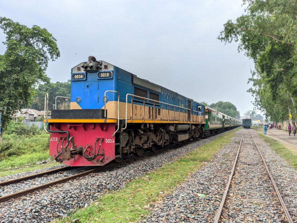 Slow travel guide: a passenger train crossing open countryside